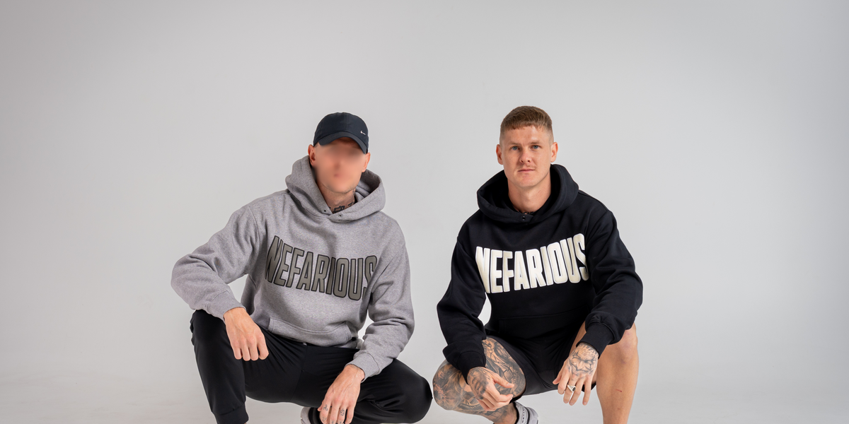 Two people wearing hoodies with 'NEFARIOUS' branding on a gray background